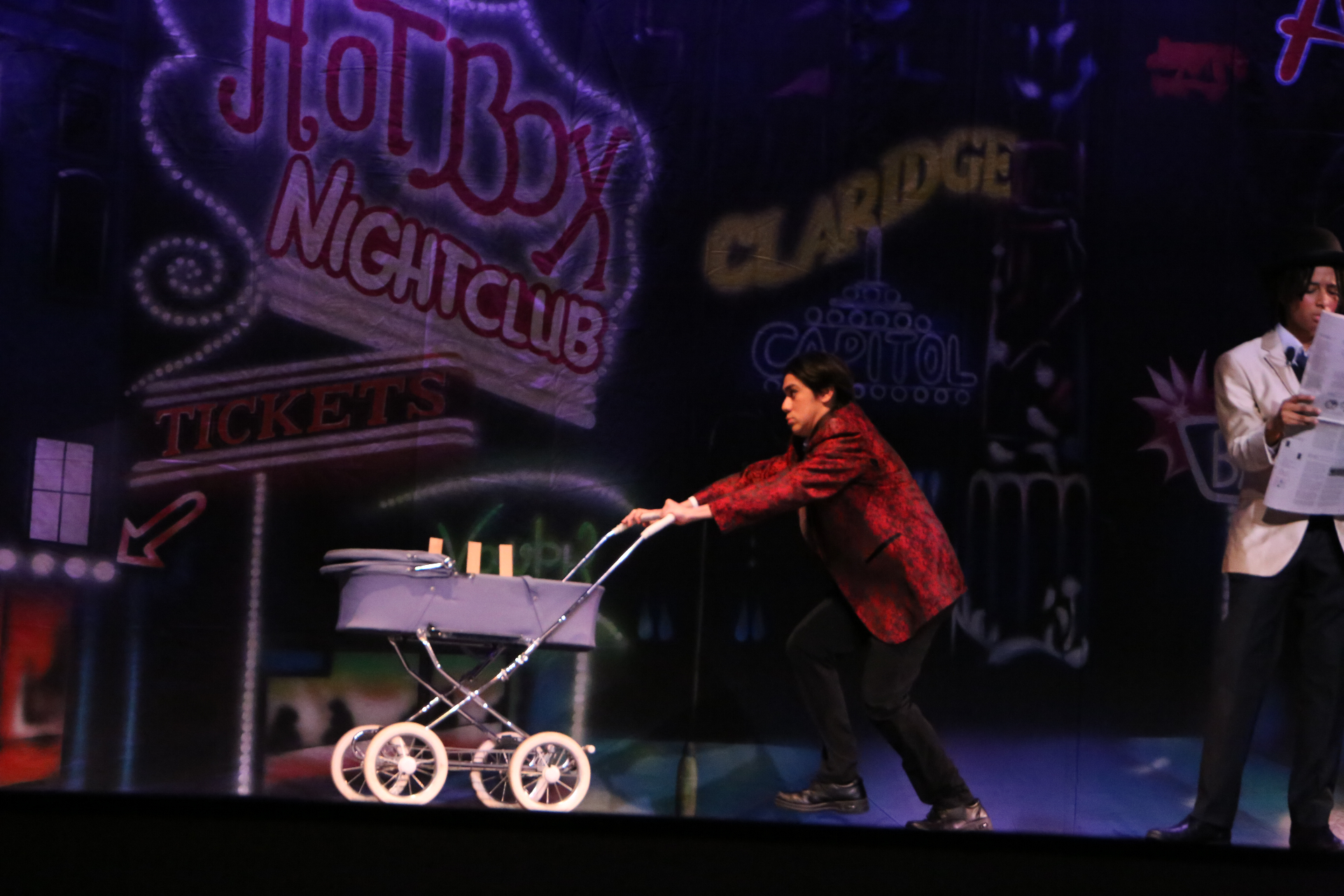 Pushing the stroller across the stage