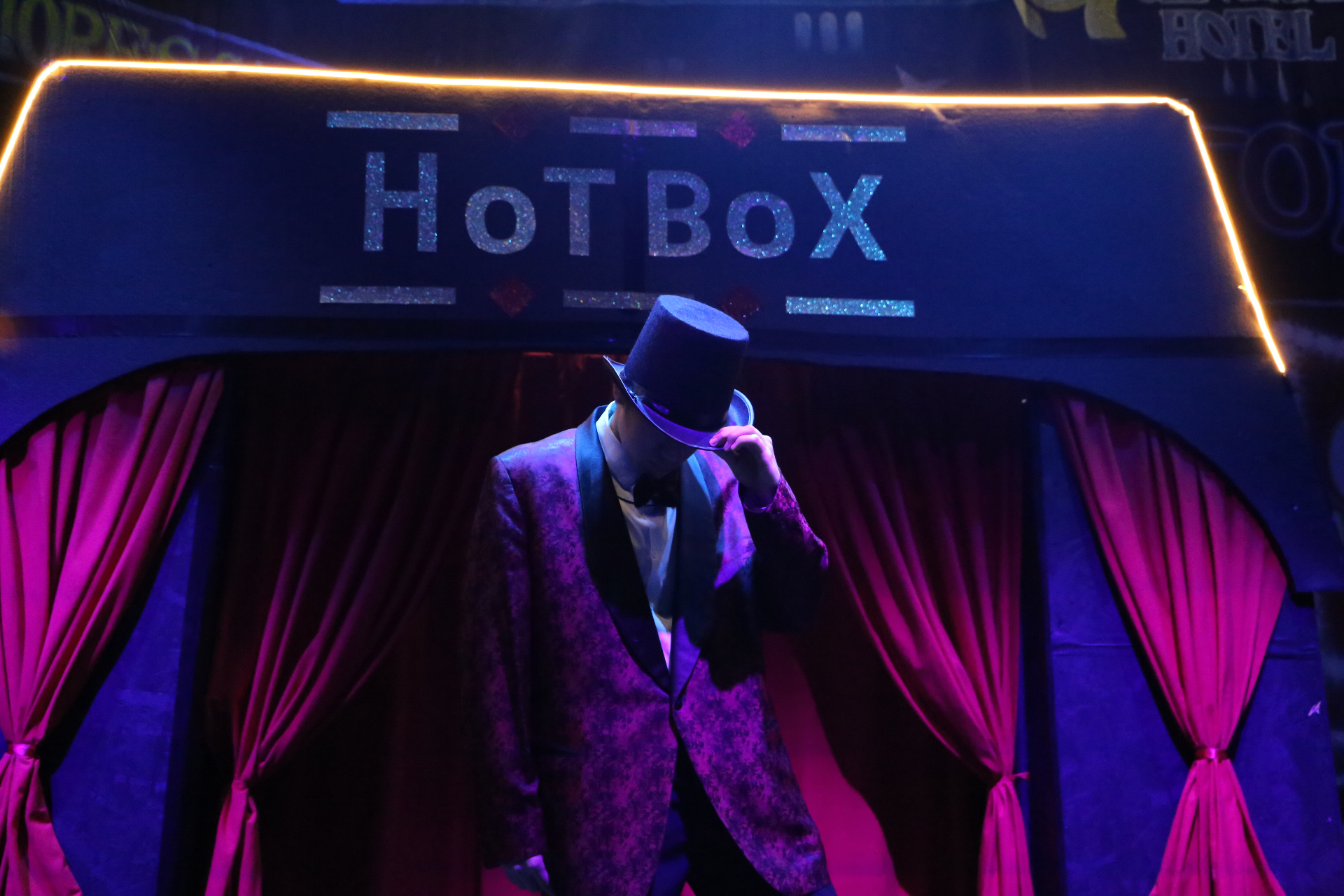 Top-hat tip pose in front of the Hot Box